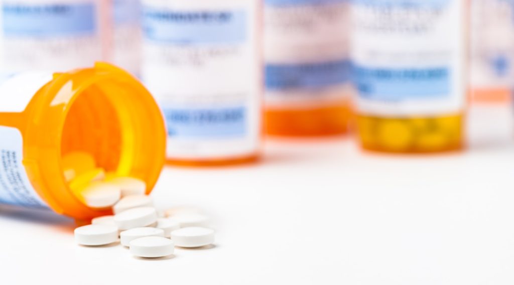 What does the thyroid do: A tipped over bottle of prescription medication