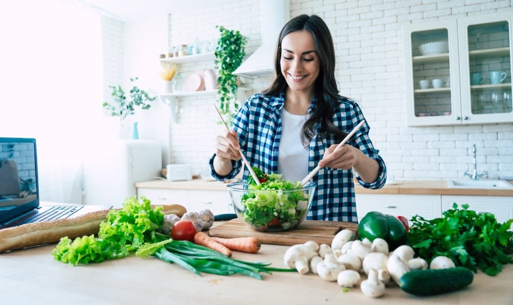 ibs diet: woman preparing vegetable salad in the kitchen