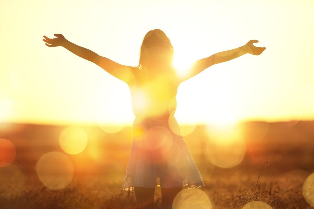 Probiotics for Constipation: woman facing sunset light in the field