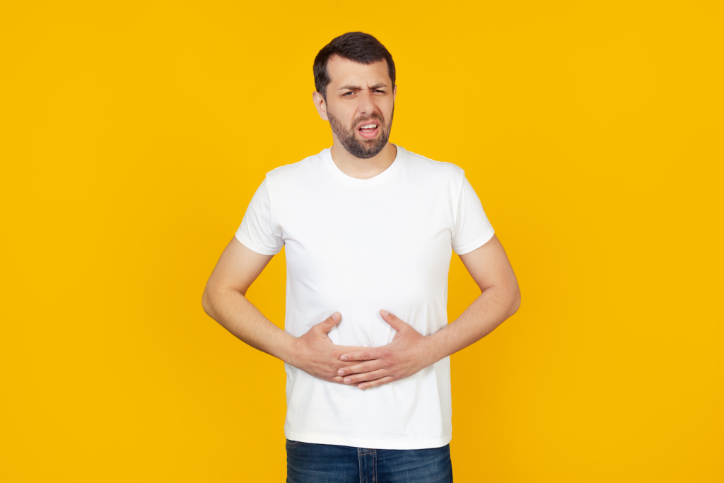 Digestive enzymes vs Probiotics: A man with stomach pain