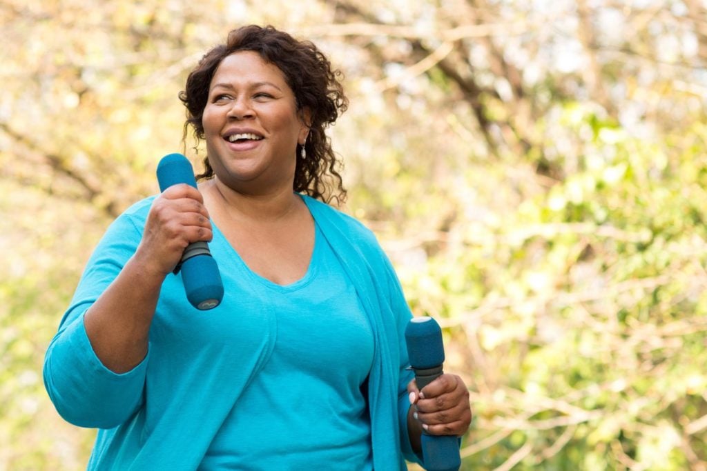 Supplements for PCOS: Woman laughing while exercising