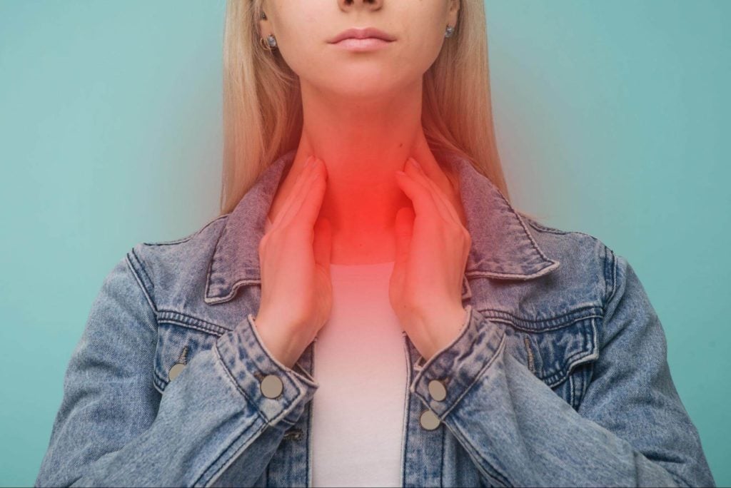 LPR symptoms: Woman in pain, touching her neck