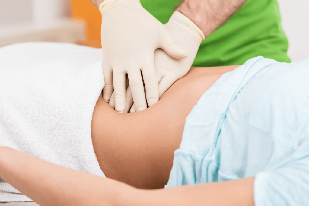 Colonic: Medical practitioner massaging a patient's abdomen