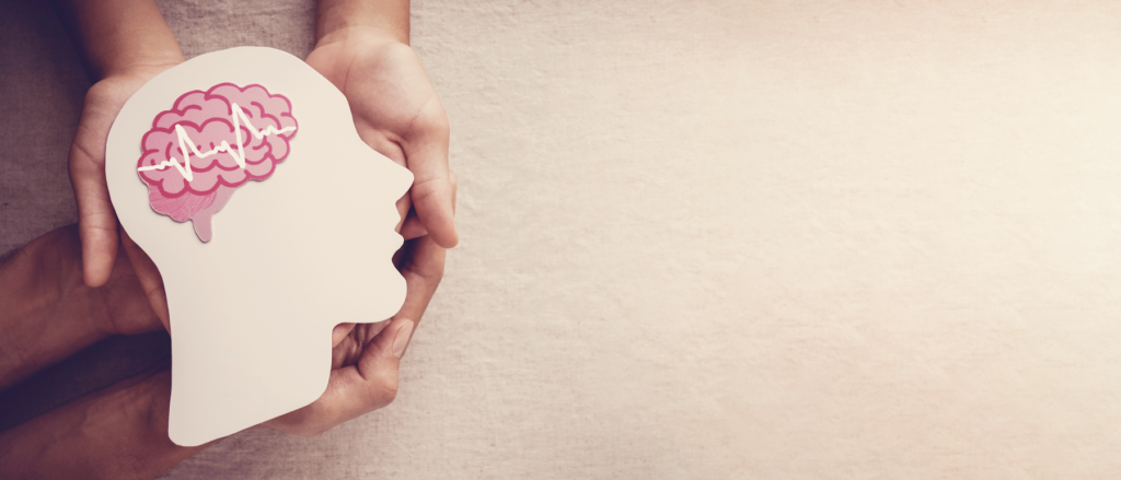 neuroplasticity training: hands holding an illustration of the brain