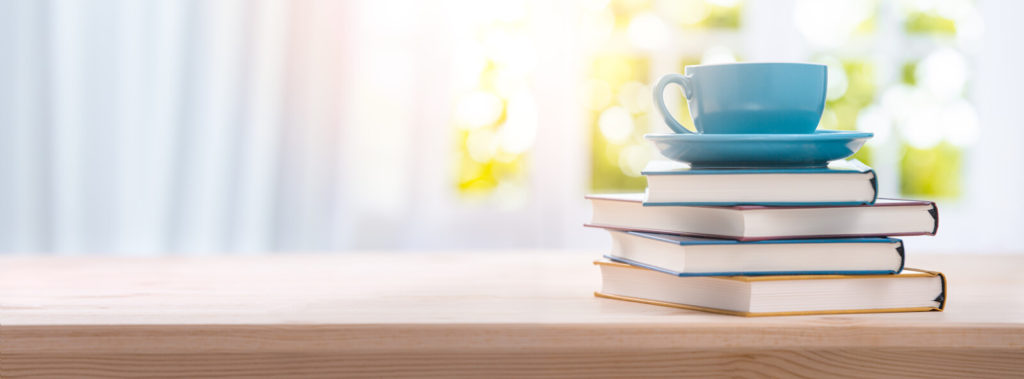Coffee cup on top of a stack of books