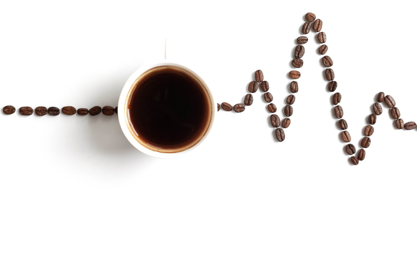 Coffee and heartbeat drawn with coffee beans