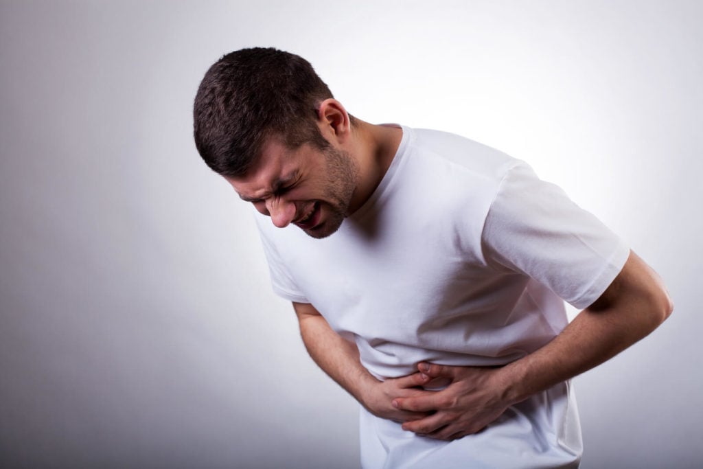 Prokinetic agents: man with a stomachache holding his stomach