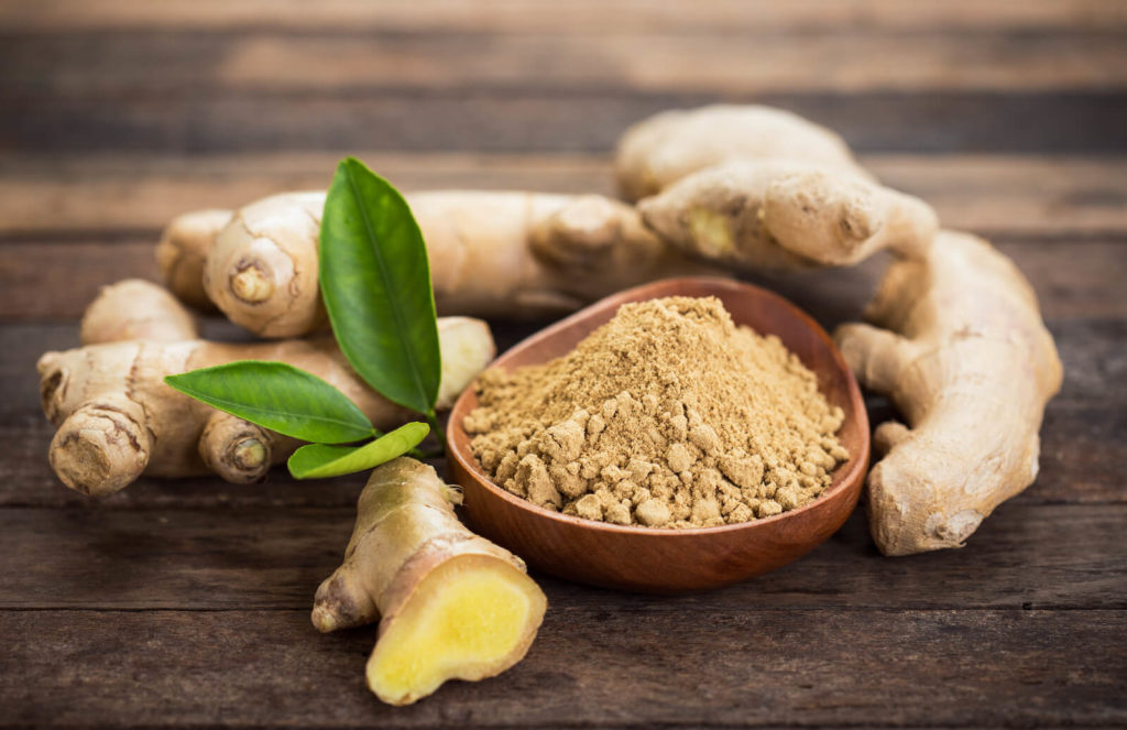 Prokinetic drugs: ginger root and ginger powder in a bowl