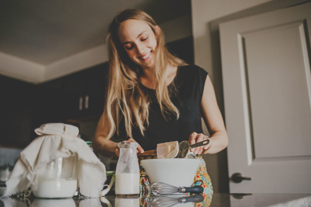 Multi strain probiotic: woman preparing food in her kitchen