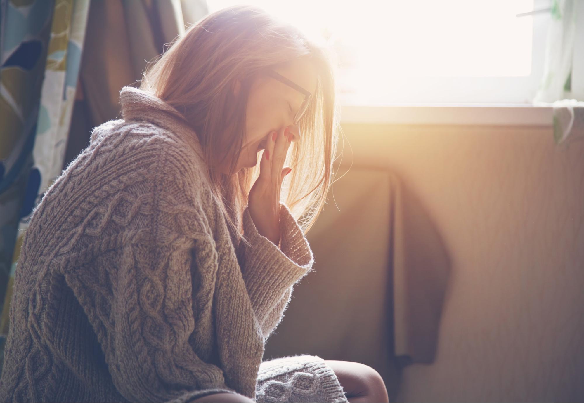 adrenal fatigue symptoms: Yawning woman with glasses