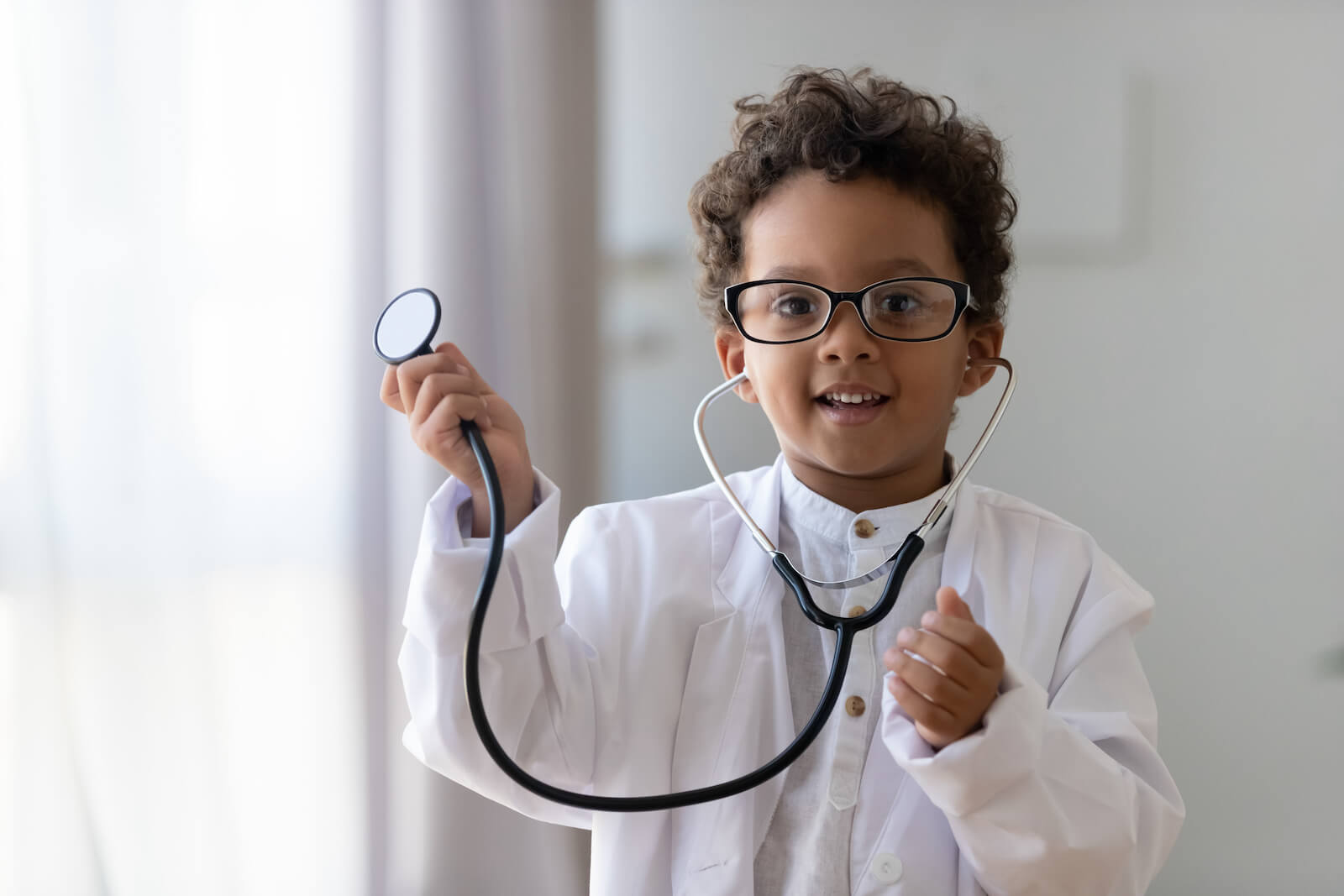 Kids probiotic: kid dressed up as a doctor holding a stethoscope