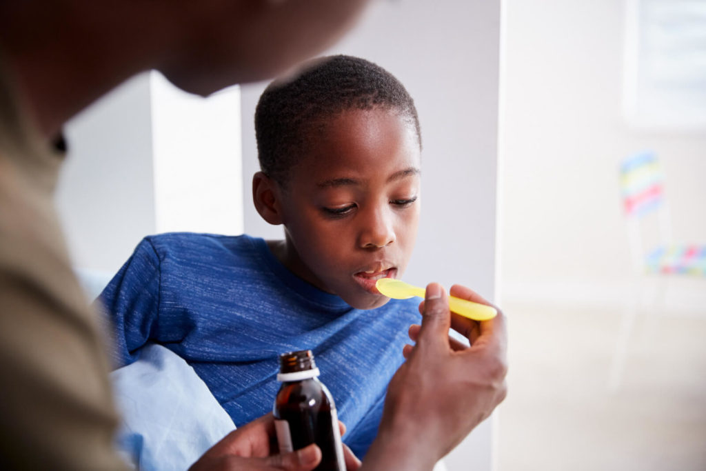 Little boy being given some medicine