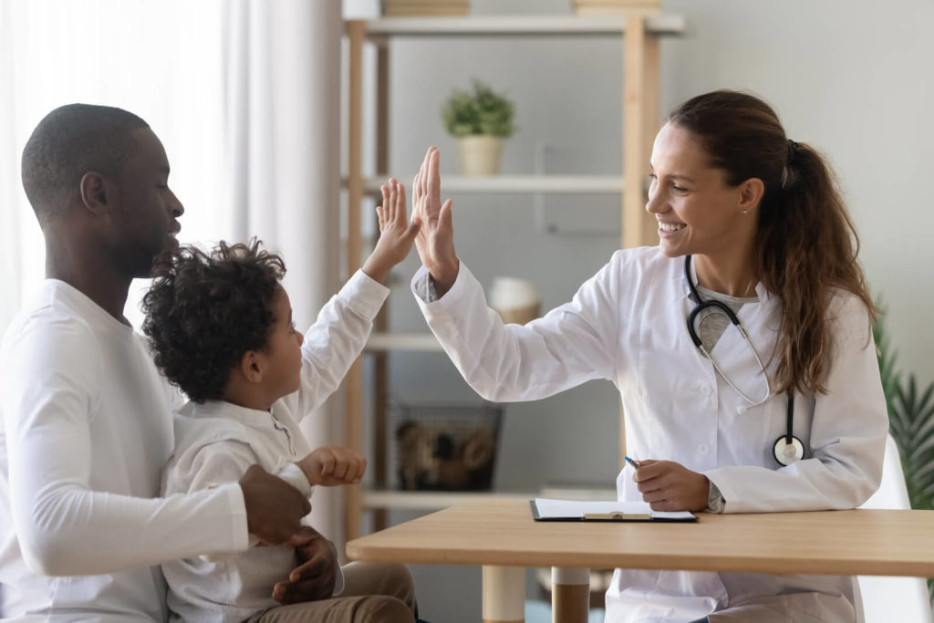 Kids probiotic: pediatrician high-fiving her patient