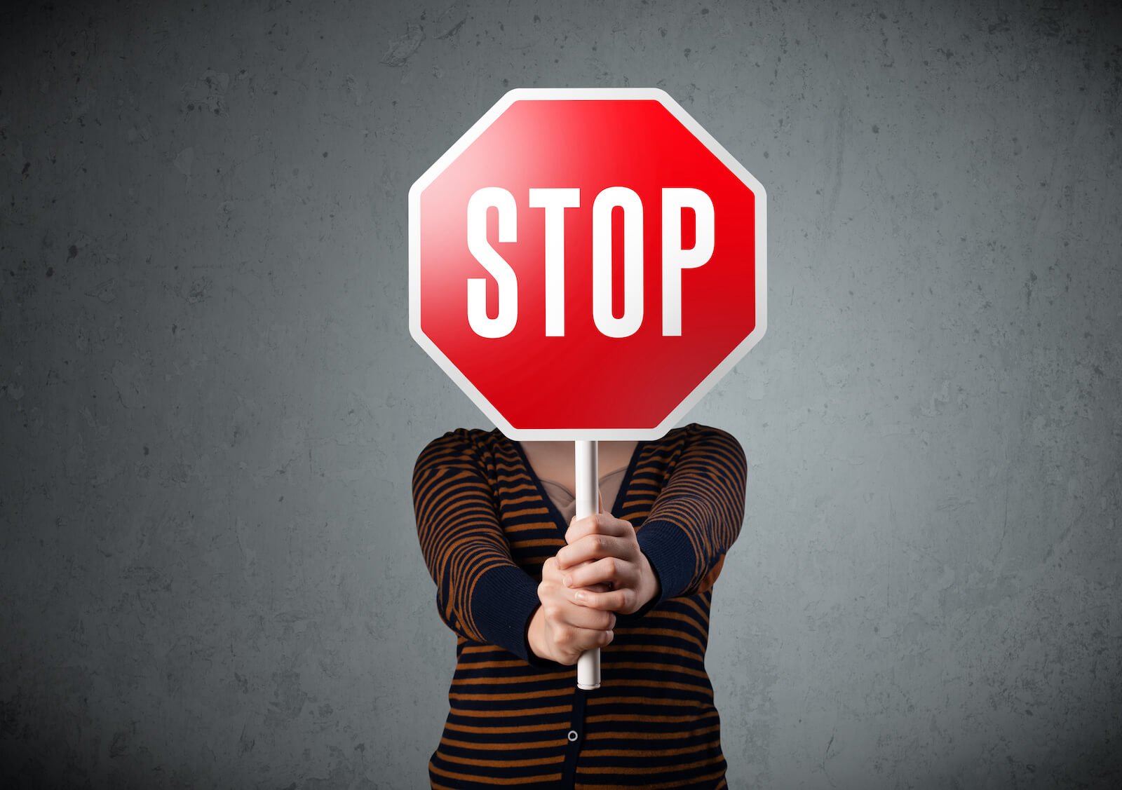 Autoimmune doctor: person holding a STOP sign