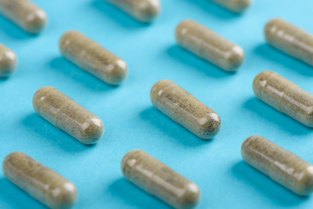 Normal microbiota: capsules lined on a blue background