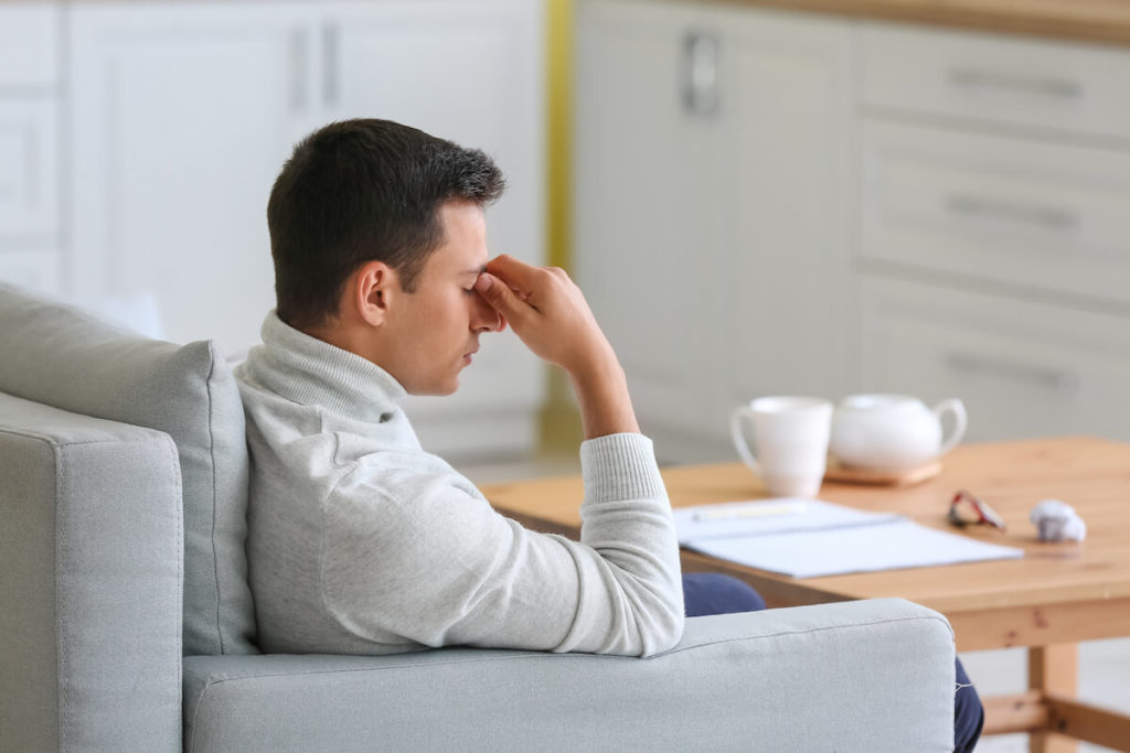Mood boosting probiotics: stressed man at home